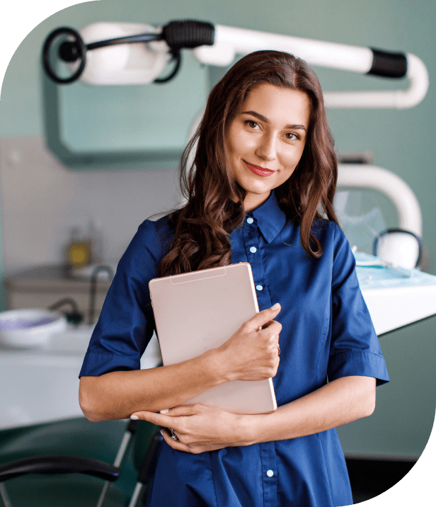 Dentist holding a tablet in clinic.
